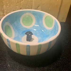 Dog bowl with a mini puppy inside.